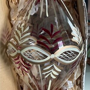 Elegant Glass Ornament with Red and Gold Accents